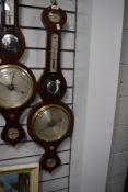 An antique banjo style barometer having a mahogany case with bulls eye mirror