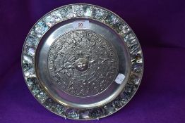 A south American wall plaque decorated with mother of pearl boarder and Aztec design