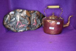 A copper stove kettle and a similar tribal style copper plaque