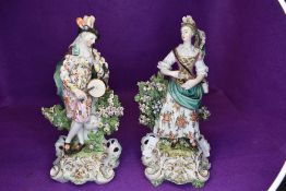 A pair of antique musician figurines,around 19th century, including gent in period clothing with