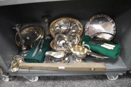 A variety of flat wear including sauce boats, cutlery, serving dishes, candle stick holders and