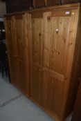 A pair of natural pine small wardrobes