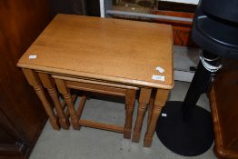 A modern golden oak nest of three tables