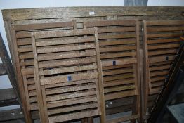 A teak garden table and set of four similar folding chairs