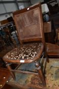 A stained frame bedroom chair having canework back