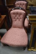 A pair of Victorian mahogany easy chair (one with arms) having later upholstery