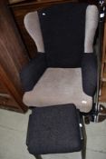 An early to mid 20th Century Queen Anne style wing back armchair in later upholstery and a