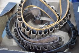 Three cartridge belts.