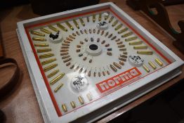 A vintage shop display of various bullets and ammunition by Norma