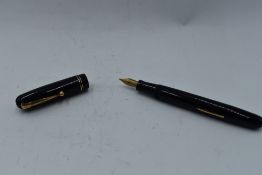A Mabie Todd & Co Swan 3260 Self Filler Leverfill, in black with two bands to the cap and a Swan No2
