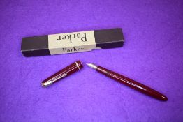 A Parker Victory fountain pen in red with decorative single band to cap, having a Parker 10 nib.