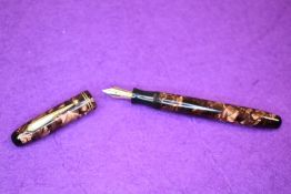 A Parker Parkette leverfill fountain pen in pink marble with two narrow bands to cap. With Parker