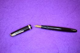 A Parker Duofold button fill fountain pen in chocolate with a single broad decorated band to cap