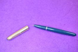 A Parker 51 fountain pen in green with a rolled gold cap. Approx 13.8cm