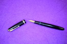 A Parker Duofold button fill fountain pen in black with a single broad decorated band to cap