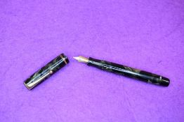A Parker Duette Moderne button fill fountain pen in green marble with single narrow band to cap