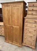 A large pine wardrobe together with a large pine chest of drawers and a pine bedside cabinet