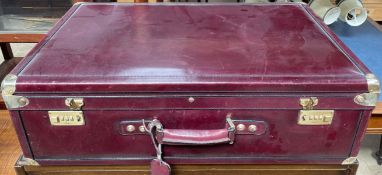 A Bugatti ox blood leather suitcase with brass corners
