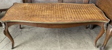 A French Kingwood coffee table with a shaped parquetry top on cabriole legs with gilt metal mounts