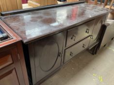A 20th century mahogany sideboard with cupboards and drawers on cabriole legs