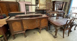 A mahogany extending dining table with pie crust edge on leaf carved cabriole legs and claw and