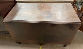 A 19th century mahogany gateleg dining table of rectangular form on square legs