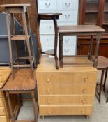 An oak chest of drawers together with a pine table,
