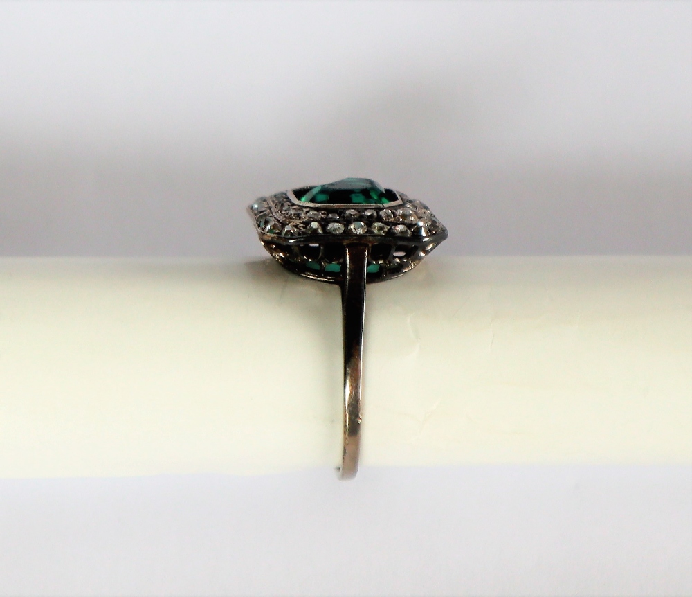 A dress ring set with diamonds and a princess cut green stone to a white metal setting and shank, - Image 7 of 7