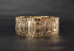 A 9ct three colour gold bracelet, with leaf and scroll decoration, 17.