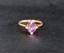 A 9ct yellow gold amethyst set ring, with an oval faceted amethyst, claw set,