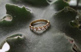 A six stone diamond line ring, set with round brilliant cut diamonds each approximately 0.