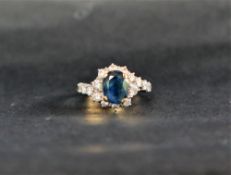 A sapphire and diamond ring, the oval faceted sapphire,