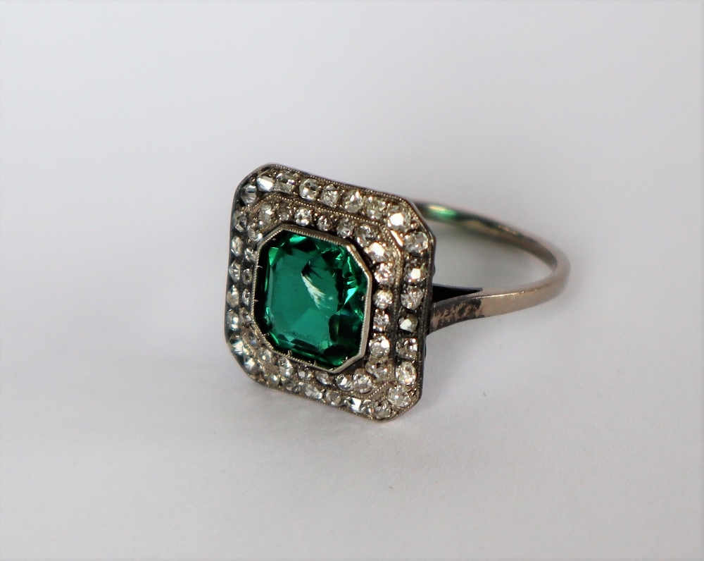 A dress ring set with diamonds and a princess cut green stone to a white metal setting and shank, - Image 3 of 7
