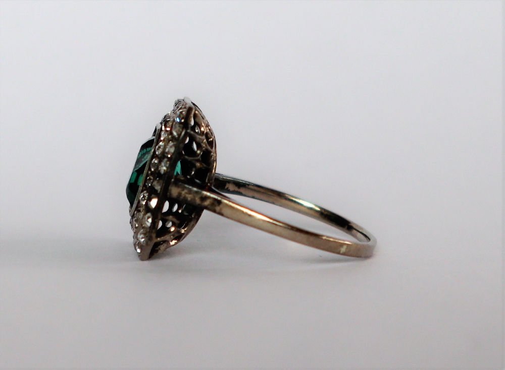 A dress ring set with diamonds and a princess cut green stone to a white metal setting and shank, - Image 4 of 7