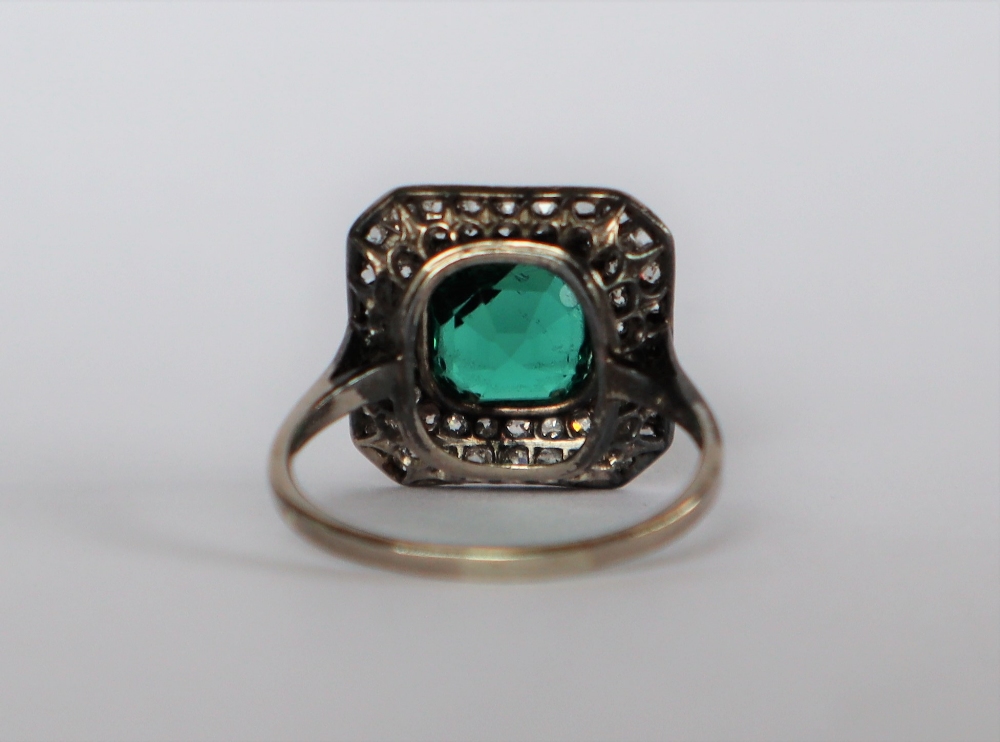 A dress ring set with diamonds and a princess cut green stone to a white metal setting and shank, - Image 6 of 7