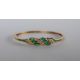 A 14ct yellow gold emerald and diamond set hinged bangle, - Image 1 of 4