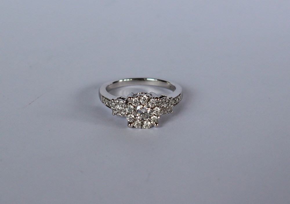 A diamond cluster ring set with a central round old cut diamond surrounded by nine round old cut