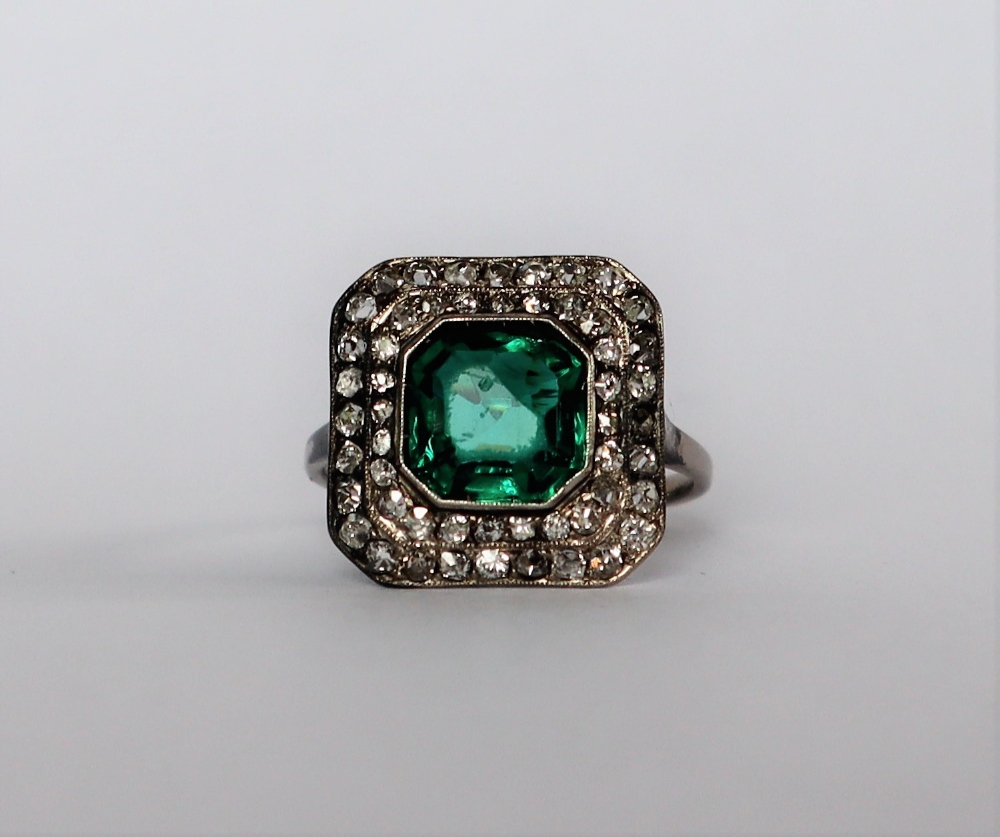 A dress ring set with diamonds and a princess cut green stone to a white metal setting and shank, - Image 2 of 7