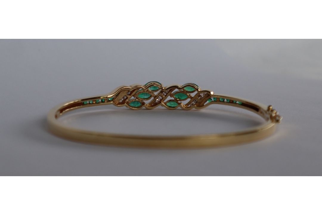 A 14ct yellow gold emerald and diamond set hinged bangle, - Image 2 of 4