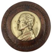 A 19th century circular brass relief profile plaque of the Duke of Wellington