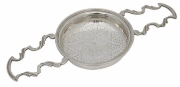 A George III silver twin handled lemon strainer
