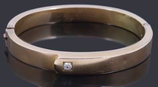 A gold single stone diamond hollow hinge bangle