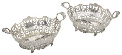 A pair of George V silver twin handled baskets in George III style