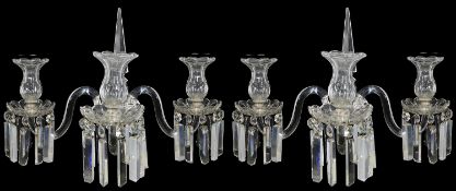 A pair of late Regency style cut glass three light wall appliques in the manner of Osler