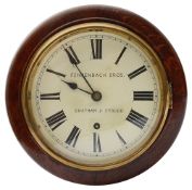 An early 20th century small oak cased circular drop dial wall clock