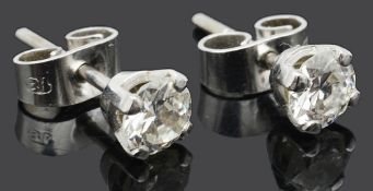A pair of small single stone diamond set stud earrings
