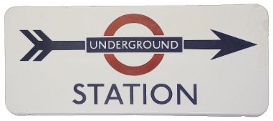 A London Underground enamel direction sign displaying 'UNDERGROUND / STATION',blue lettering on
