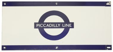 A London Underground enamel station frieze sign for 'PICCADILLY LINE',blue edging and roundel on