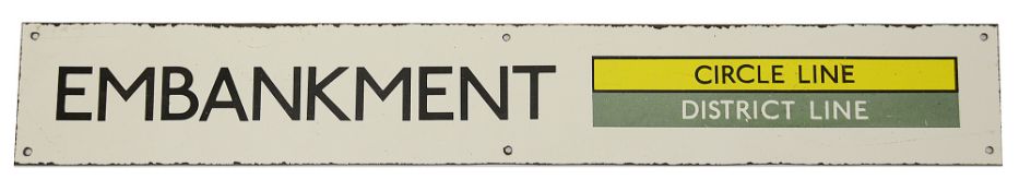 A London Underground enamel station sign for Embankment,with black lettering on a white ground and a