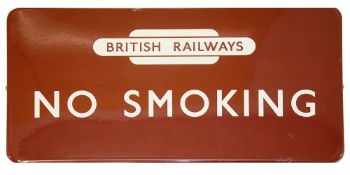 A BR(M) enamel sign displaying 'NO SMOKING' with British Railways totem,white lettering on maroon